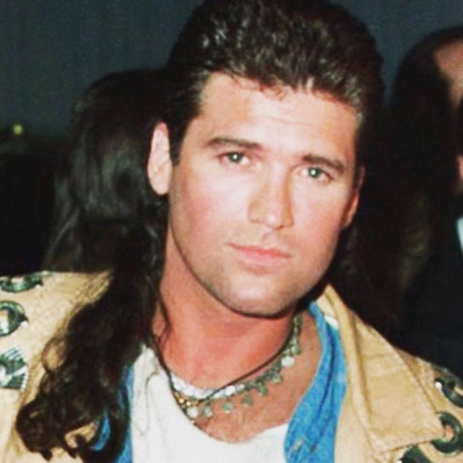 Billy Ray Cyrus with his backup singer, his mullet. 